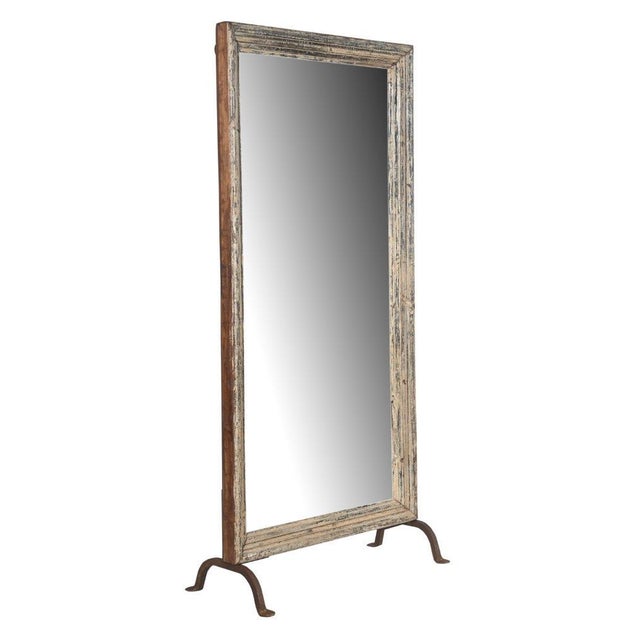 This Vintage Indian Carved and Bleached Teakwood Mirror on Iron Legs is a sophisticated floor-standing mirror handcrafted...