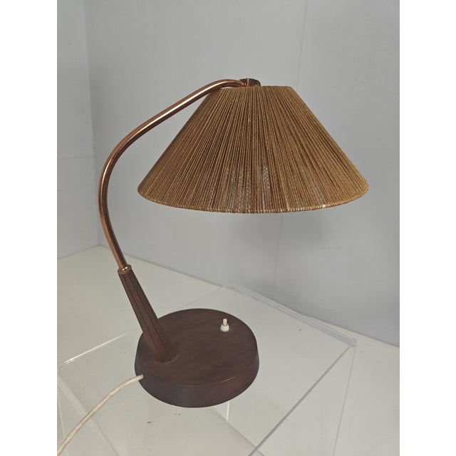 This elegant Mid-Century Modern table lamp was manufactured in the 1960s by the renowned German-Swiss maker Temde. It...