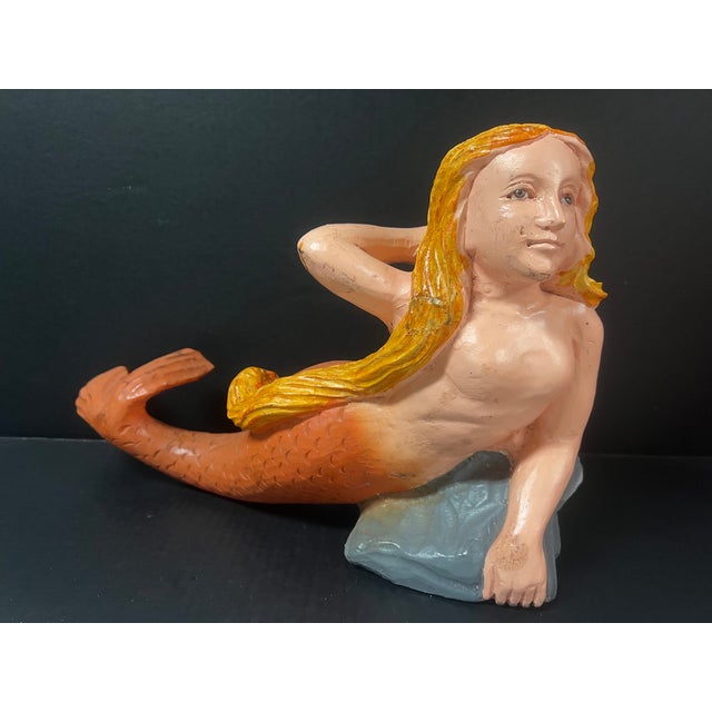 ITEM NAME: Folk Art Carved Wood Mermaid Sculpture with Gold Hair and Orange Tail and Glass Eyes ORIGIN: Philippines AGES:...