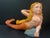 ITEM NAME: Folk Art Carved Wood Mermaid Sculpture with Gold Hair and Orange Tail and Glass Eyes ORIGIN: Philippines AGES:...