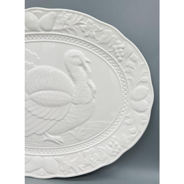 Classic, vintage white ceramic turkey platter featuring a beautifully embossed turkey surrounded by a border of fruits,...