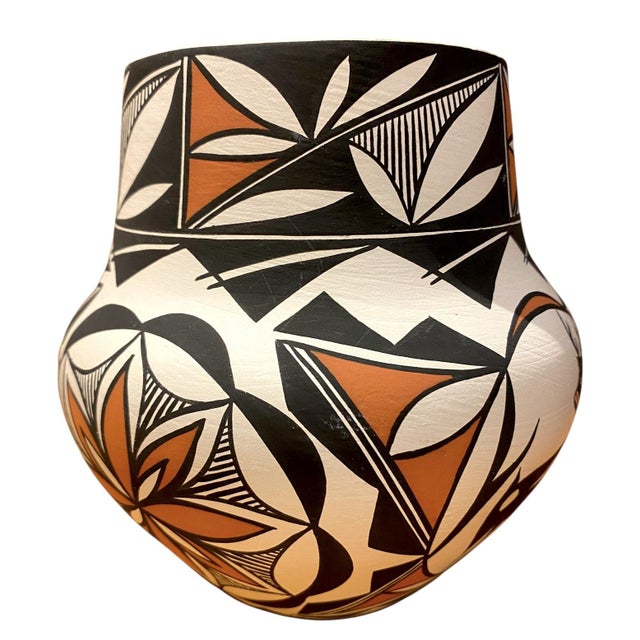 This is a stunning hand-coiled pottery vase by renowned Acoma Pueblo artist Louise Amos (New Mexico), featuring a...