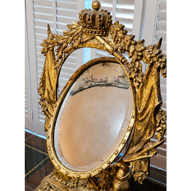 Magnificent antique-style tabletop vanity mirror featuring an exceptionally ornate gilt frame with crown crest, draped...