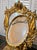 Magnificent antique-style tabletop vanity mirror featuring an exceptionally ornate gilt frame with crown crest, draped...