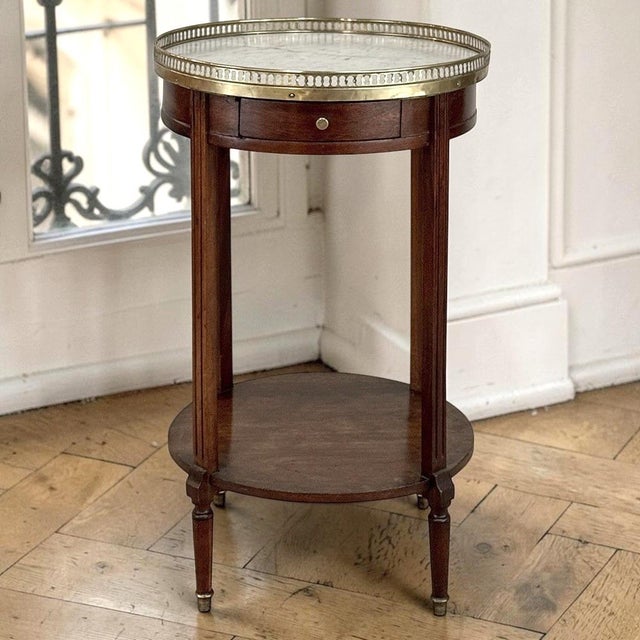 True Parisian elegance defines this Louis XVI style mahogany table, crafted with graceful proportions and restrained...