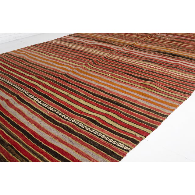This is a vintage Turkish Oushak rug from the Mid 20th Century. The piece was hand-knotted.