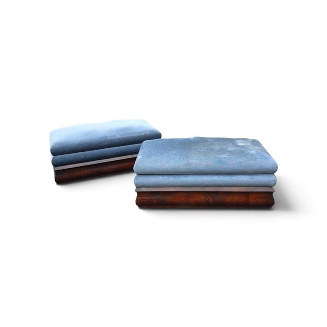 Pair of American Empire figured mahogany box-seat ottomans, dating to circa 1840–1860. Each ottoman features a generously...