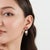 Crafted in 925 sterling silver, these elegant earrings feature pear and round-cut rubies totaling 3.75 carats, beautifully...