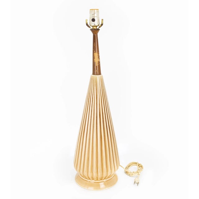 Mid Century Walnut and Ceramic Pottery Cone Table Lamp This piece measures: 7 wide x 7 deep x 25 inches high and weighs...