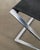 A rare and early danish mid century folded "pk91" stool in brushed chromed steel with a black leather seat designed by...