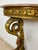 Elegant Italian demi-lune table crafted in carved and polychromed wood, featuring a shaped marble top and an impressive...