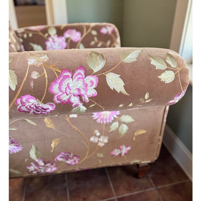 Custom armchair paired with a matching ottoman, upholstered in luxurious imported French velvet. This timeless English...