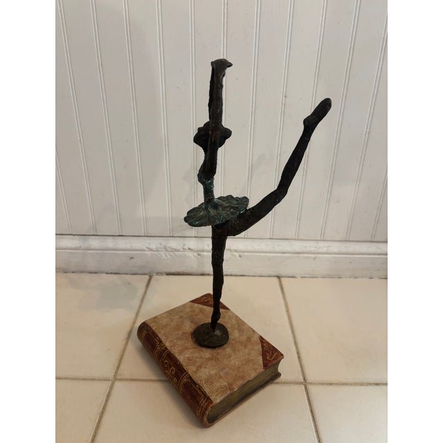 A classic Degas bronze copy of a ballerina perched upon a book, likely by Maitland Smith. Even though it is unmarked, it...
