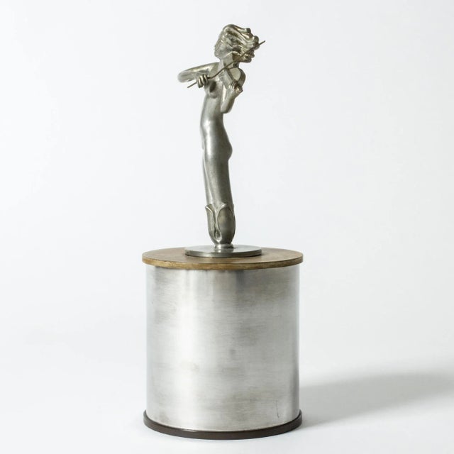 Striking pewter jar by Ivar Ålenius-Björk, with the lid adorned with a beautiful violin-playing woman. Bakelite lid and...