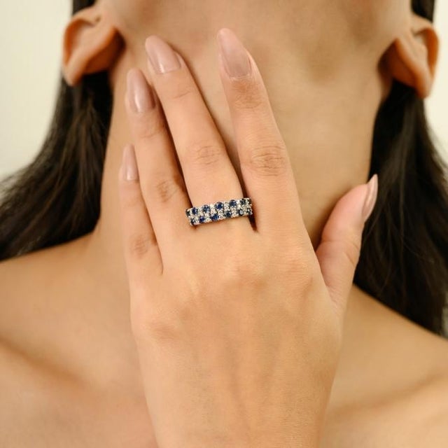 This elegant half eternity band ring feature 13 round cut blue sapphire totaling 1.14 carats, set in 18k white gold. The...