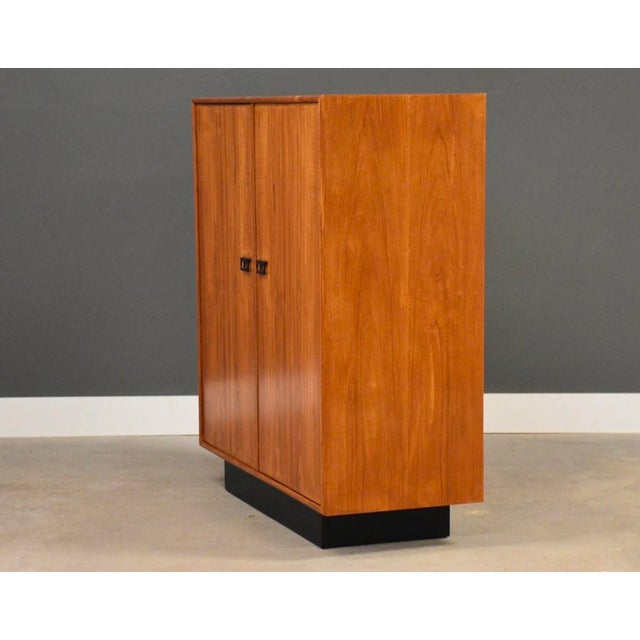 A mid century modern teak armoire dresser with lots of drawer space and a black plinth base. Made in Canada. Circa 1970’s....