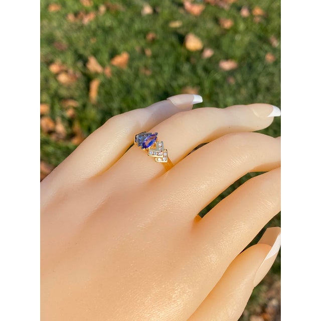 The 12th Avenue: Marquise Tanzanite and Diamond Ring in Yellow Gold. This ring spotlights a marquise brilliant-cut...