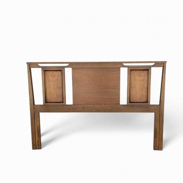 A vintage full-size wood headboard and footboard with a quiet panel design and warm walnut-toned finish. The low,...