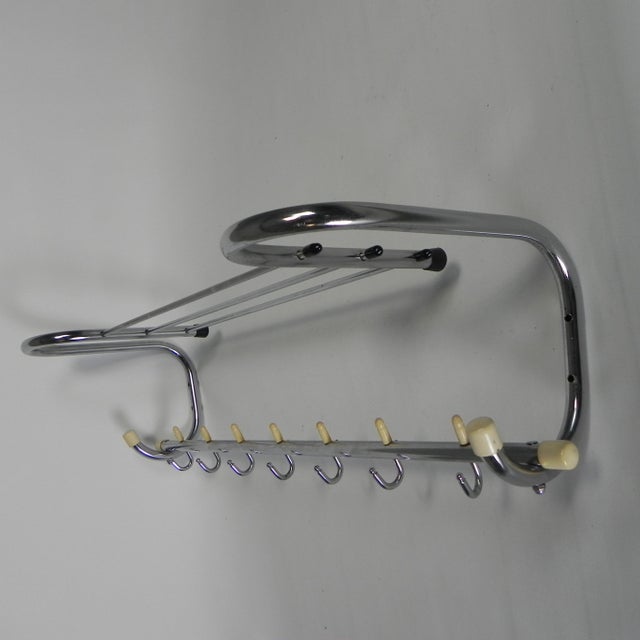 Mid-century wall coat rack from the 1950s made of chrome-plated steel. Compact, functional, and durable design with...