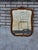 The 1920 oak bathroom mirror is an antique piece with a rectangular shape and a brown color. It features a mirrored frame...