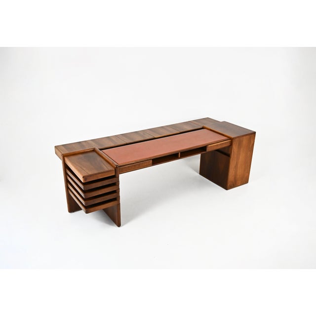 A wooden and leather desk with ample storage, designed by Fabio Lenci for Bernini. Stamped Bernini. Shows signs of wear...