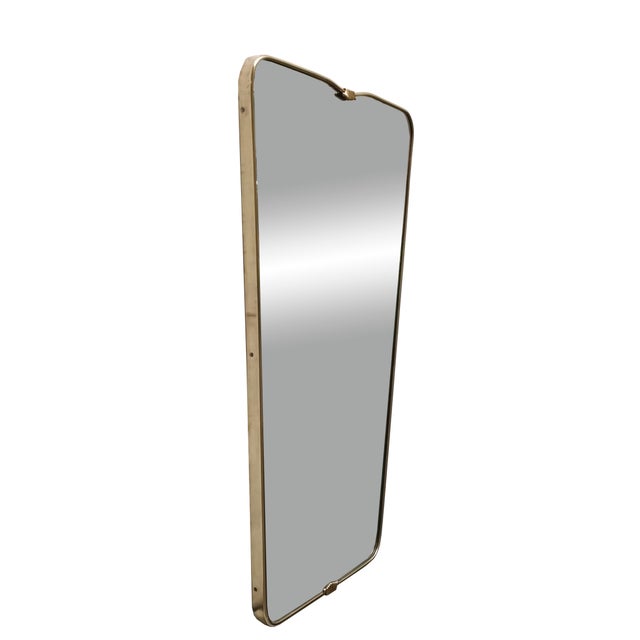 An extremely rare wall mirror with a solid brass frame and mouldings, featuring an authentic period mirror in the style of...