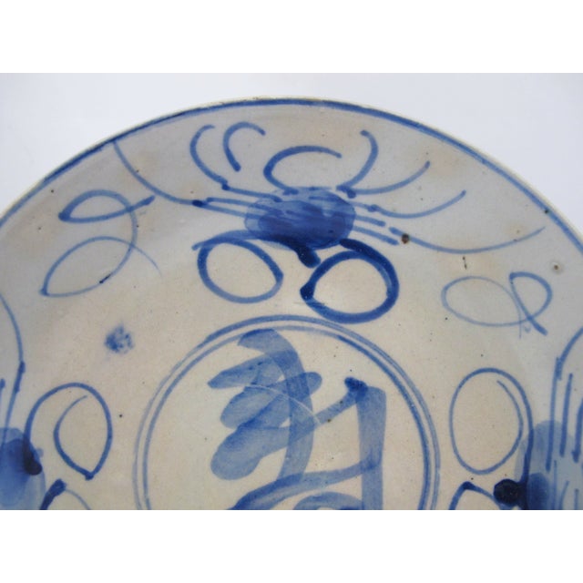 Chinese Swatow ware shallow bowl or saucer. White porcelain with blue crab motif at rim and Chinese character center....