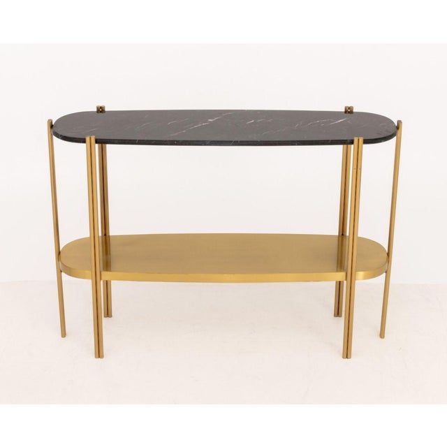 Luxxu "Craig" Black Marble Top Two-Tier Brass Console Table. 33.5" H x 48.25" W x 13.25" D. Provenance: From a Fifth...