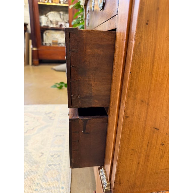 This 19th century French chest of drawers with ornate brass pulls feels fresh and functional again with addition of...