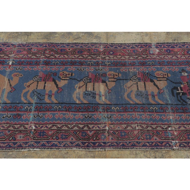 Hand-knotted in wool, this 3x5 vintage Anatolian runner rug from Turkey is a charming example of tribal weaving,...