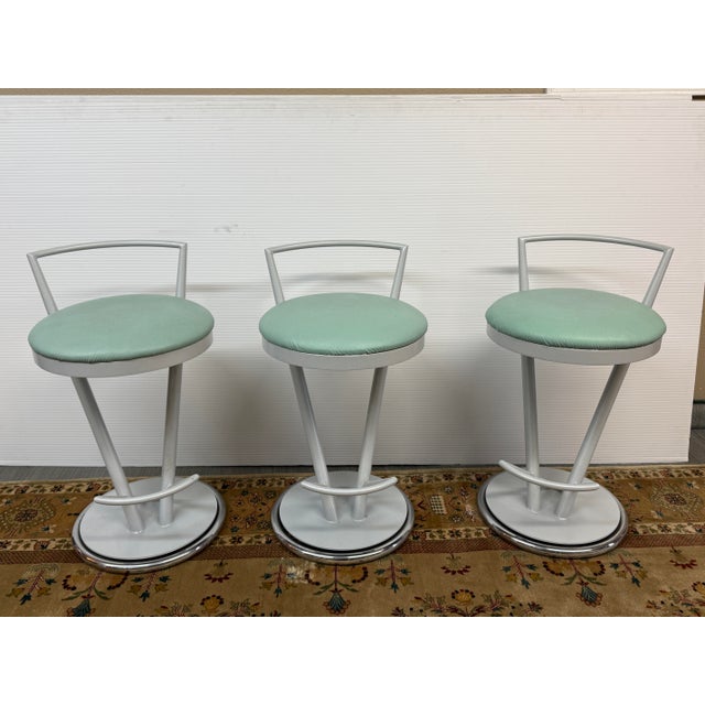 Design Plus Gallery presents a Set of Three Post Modern Counter Stools. The stools have an aerodynamic, space aged, retro...