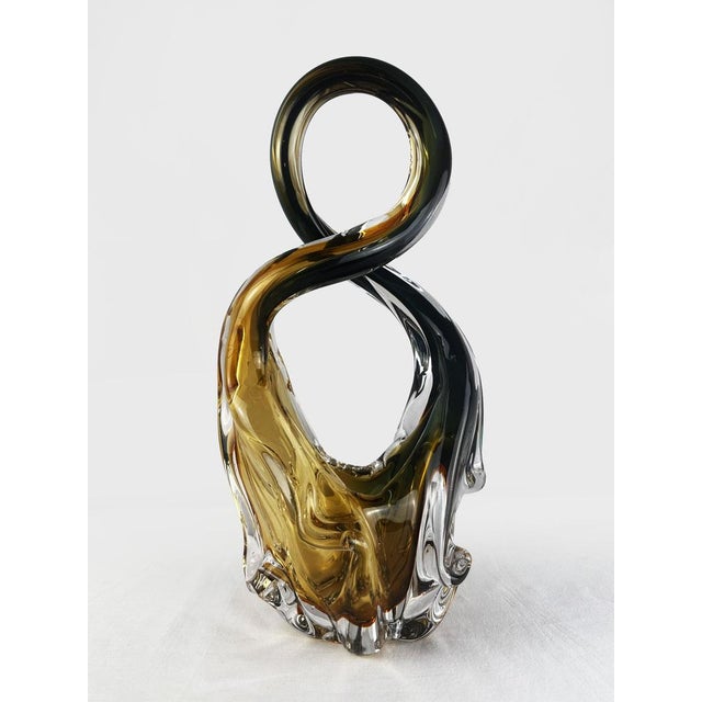 A substantial and visually arresting work in art glass, this large vintage sculpture takes the form of a fluid, twisted...