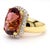 18K yellow gold cocktail ring sets an 18.75-carat checkerboard cushion-cut pink tourmaline surrounded by a round cut...