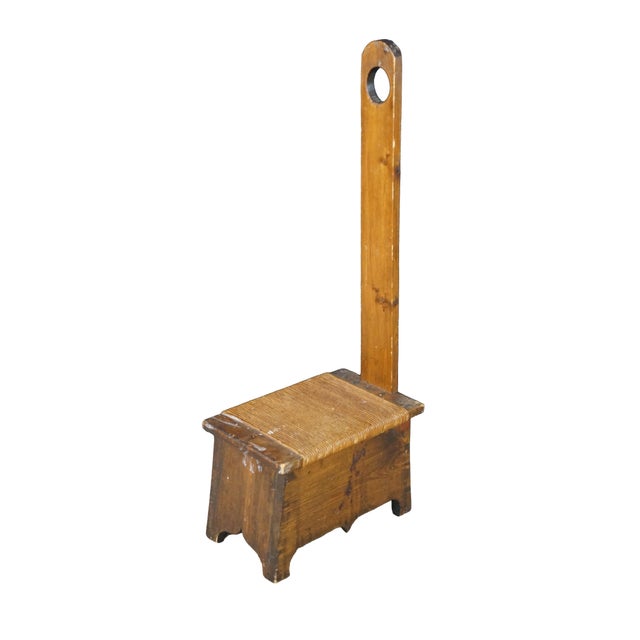 A unique antique European primitive spinning chair or bearer stool beautifully illustrates the functional charm of...