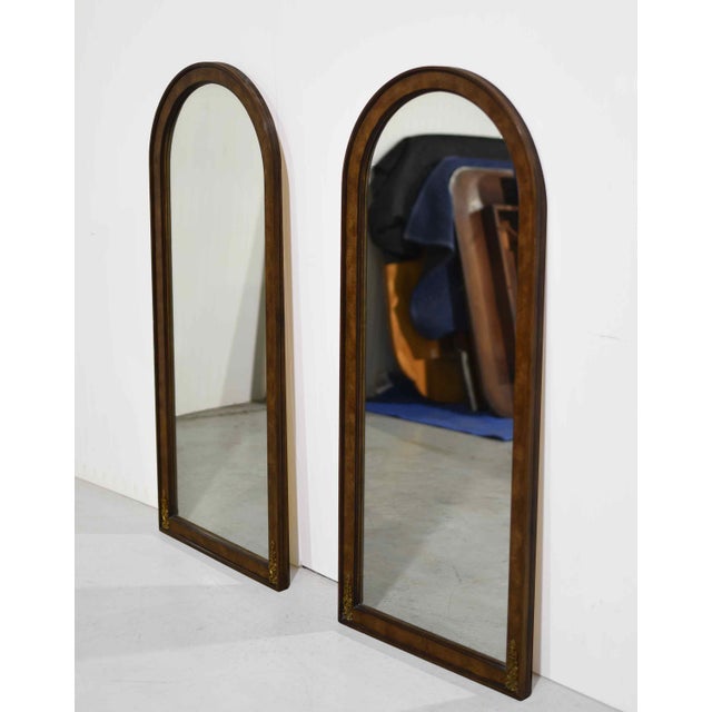 Elegant and dramatic, this pair of 1970s Hollywood Regency wall mirrors blends neoclassical design with the rich texture...