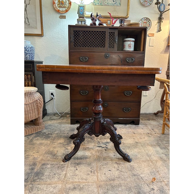 Handsome 19th century William IV console game table handcrafted in mahogany with a fliptop as a console or opens to a...