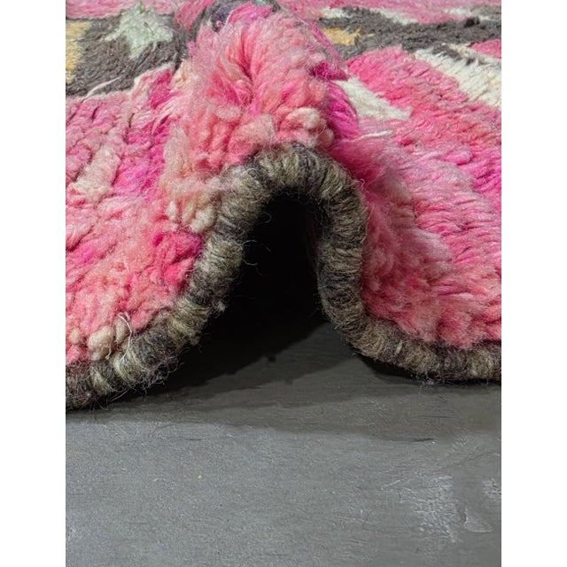 Pink Sunset Totem Moroccan Wool Rug This striking Moroccan wool rug features a vibrant pink backdrop paired with a bold,...