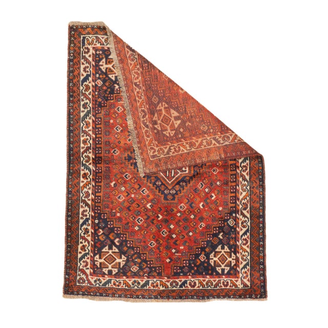 Vintage hand-knotted Persian Qashqai Shiraz rug with a stepped diamond medallion set within a field of small repeating...