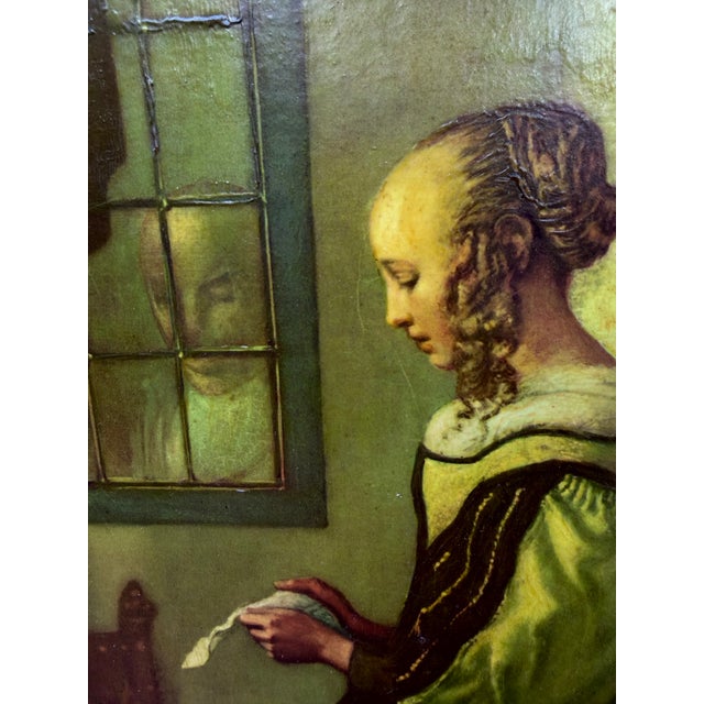 This is a reproduction of Johannes Vermeer's "Girl Reading a Letter at an Open Window" (c. 1657–1659), a masterpiece of...