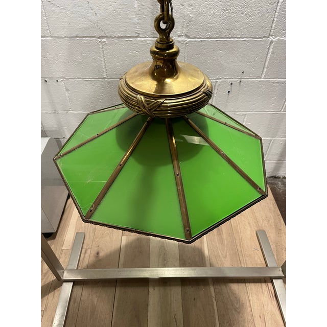 A striking vintage pendant chandelier pairing rich green glass with substantial brass construction. Eight glass panels...