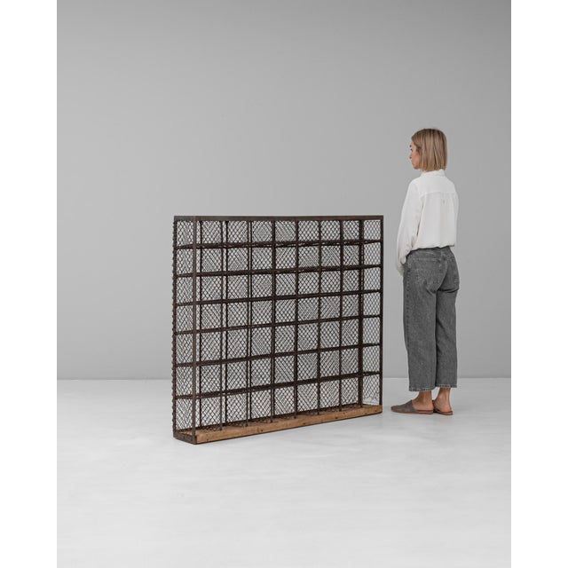 This 20th-century French metal shelf is an exceptional example of industrial-era craftsmanship. The structure features a...