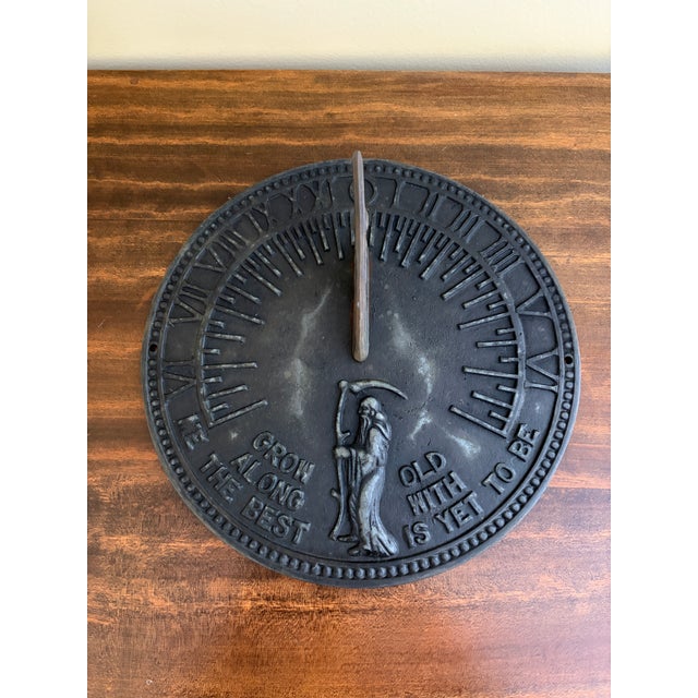 A stunning vintage iron garden sundial reading "Grow old along with me. The best is yet to be." Late 20th Century...