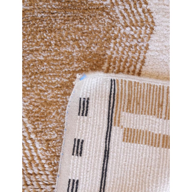 This Neutral Moroccan Wool Rug measures 8.7 by 7.2 feet, offering a perfect blend of traditional craftsmanship and modern...