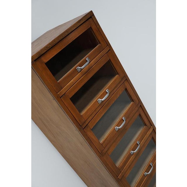 This haberdashery cabinet was produced during the 1950s in Germany. It features 8 drawers in beech with glass fronts and...