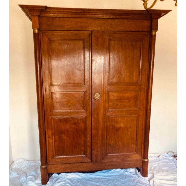 French Empire large scale armoire in walnut with gilt bronze mounts