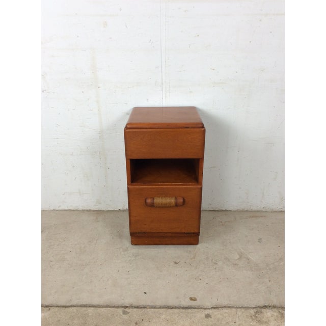 This mid century modern nightstand by Heywood Wakefield features hardwood construction, unique drop front cabinet with...