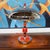 An Art Deco style dome lamp. Crimson and black bakelite and chromed metal stem with a chromed metal mushroom shade and...