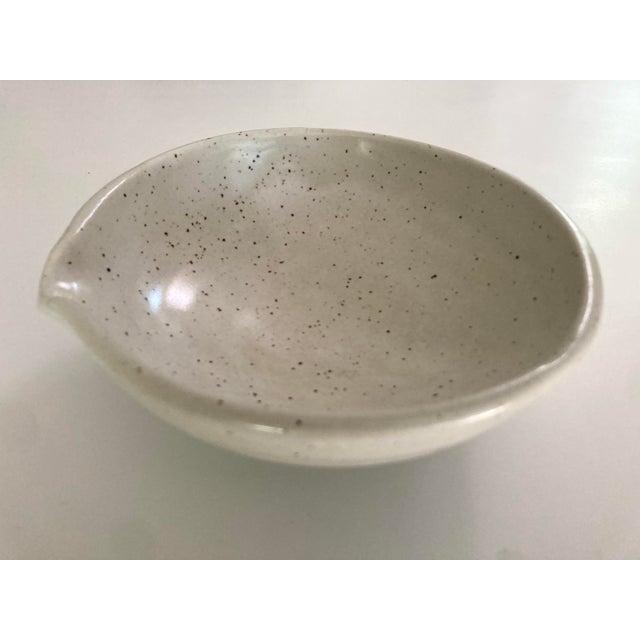 A well crafted mortar form Glazed Ceramic Bowl with spout and good weight having a fine natural Speckled Cream color....