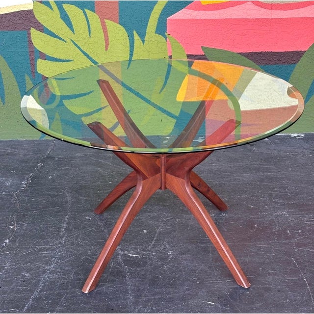 A striking mid century designed table done in the manner of Adrian Pearsall’s iconic Jacks style. Solid walnut base and a...