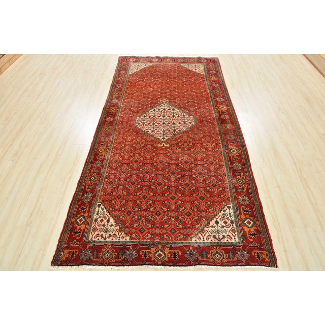 An authentic semi-antique tribal Bidjar rug hand-knotted with fine wool and natural dyes. This oriental rug features a...